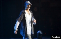 Singer Justin Bieber walks on stage during a concert in Oslo, Oct. 29, 2015.