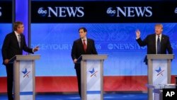 Candidates Jeb Bush, left, and Donald Trump, right, spar as Sen. Marco Rubio listens in the middle during a Republican presidential debate at St. Anselm College, Feb. 6, 2016, in Manchester, N.H.