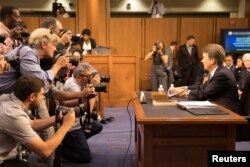 Supreme Court nominee Brett Kavanaugh faces photographers as he prepares to testify during the third day of his confirmation hearing before the Senate Judiciary Committee on Capitol Hill in Washington, Sept. 6, 2018.
