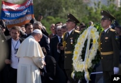 FILE - Pope Francis, left, attends a ceremony at a memorial to Armenians killed by Ottoman Turks during World War I, in Yerevan, Armenia, June 25, 2016.
