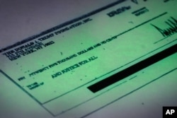 A Sept. 15, 2016 copy provided by the New York state attorney general shows a $25,000 check from the Donald J. Trump Foundation to And Justice For All signed by Donald J. Trump. The $25,000 check was sent from his personal foundation to a political commit