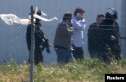 Unidentified people leave the hijacked Egyptair Airbus A320 at Larnaca Airport in Larnaca, Cyprus, March 29, 2016.