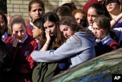 Students from the Yeshiva School in the Squirrel Hill neighborhood of Pittsburgh stand outside Beth Shalom Synagogue after attending the funeral service for Joyce Fienberg, Oct. 31, 2018.