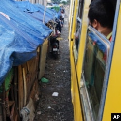 A train moves out of Phnom Penh along the refurbished line running south to the town of Touk Meas in late October. The homes of people living alongside the track will be demolished in due course.