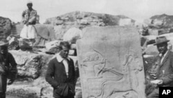 In this 1913 photo, a young T.E. Lawrence (of Arabia), left, is pictured in front of the Long Wall of Sculpture in ancient Turkey. (Photo courtesy of the Joint Turco-Italian Archaeological Expedition)