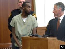 FILE - Abdirahman Sheik Mohamud, left, speaks with his attorney, Sam Shamansky, during a hearing to set bond on charges of money laundering and providing support for terrorism in Columbus, Ohio, Feb. 25, 2015.