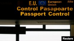 FILE - An EU sign is seen in the passport control area at Bucharest's Henri Coanda International Airport, Jan. 1, 2007. Many Turks are hoping a just concluded refugee deal with Brussels will eventually offer them visa-free travel in the EU.