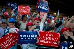 FILE - Supporters of Donald Trump cheer as he arrives to a campaign rally, Sept. 17, 2016, in Colorado Springs, Colo.