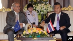 FILE - European Union delegation chief Cesar Deben, left, meets Thai Deputy Prime Minister and Defense Minister Prawit Wongsuwan in Bangkok, Thailand, Jan. 22, 2016. The EU is maintaining the threat of a seafood import ban on Thailand.