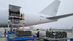 Workers and Ukrainian servicemen unload a shipment of ammunition delivered as part of U.S. security assistance to Ukraine, at the Boryspil International Airport outside Kyiv, Ukraine November 14, 2021. (Press service of the U.S. Embassy in Ukraine/Handout
