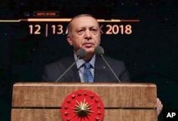 Turkey's President Recep Tayyip Erdogan delivers a speech during a defense industry meeting event in Ankara, Turkey, Dec. 12, 2018.