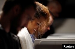 Voter Rita Davis smiles as she marks her ballot in the 2018 U.S. midterm elections at a Fulton County polling place in Atlanta, Ga., Nov. 6, 2018. Young voters helped Democrats win back a majority in the House of Representatives, analysts say.