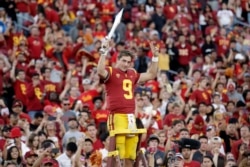 FILE - Southern California quarterback Kedon Slovis (9) directs the school's band after a 52-35 win over UCLA in an NCAA college football game, Saturday, Nov. 23, 2019, in Los Angeles. (AP Photo/Marcio Jose Sanchez)