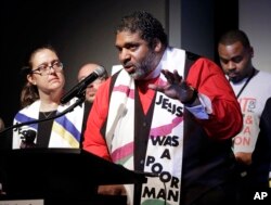 The Rev. Dr. William J. Barber II, center, and Rev. Dr. Liz Theoharis, left, co-chairs of the Poor People's Campaign, speak at the National Civil Rights Museum in Memphis, Tennessee, April 3, 2018.