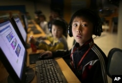 A North Korean school boy looks up from his computer screen at the Sci-Tech Complex in Pyongyang, April 17, 2017.