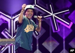 FILE - Bruno Mars performs at the 2016 Jingle Ball at the Staples Center in Los Angeles, Dec. 2, 2016.