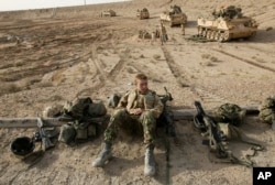 FILE - In this March 27, 2003 file photo, British tank crews wait on the front line at Basra.