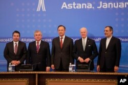 From left, Turkish Foreign Ministry Deputy Undersecretary Sedat Onal, Russia's special envoy on Syria Alexander Lavrentiev, Kazakh Foreign Minister Kairat Abdrakhmanov, UN Syria envoy Staffan de Mistura and Iran's Deputy Foreign Minister Hossein Jaber Ansari pose for a photo following the talks on Syrian peace in Astana, Kazakhstan, Jan. 24, 2017.