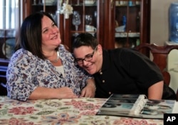 Beth Guardino, left, and her son, Christian, talk about the 17-year-old's life before and after gene therapy treatment for his hereditary blindness during an interview at their home in Patchogue, N.Y., Oct. 2, 2017.