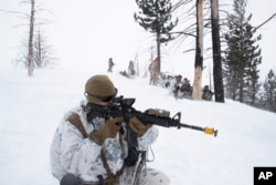 U.S. Marines take their positions during advanced cold-weather training at the Marine Corps Mountain Warfare Training Center Sunday, Feb. 10, 2019, in Bridgeport, Calif. (AP Photo/Jae C. Hong)