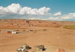 FILE - This Navajo home stands isolated in a small canyon east of Tuba City, Ariz. Radio is often the only way to get news and information out to tribal members in rural reservations.