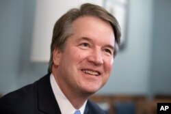 FILE - Supreme Court nominee Judge Brett Kavanaugh smiles during a meeting with Sen. Mike Lee, R-Utah, on Capitol Hill in Washington, July 18, 2018.