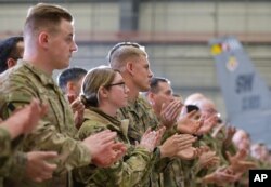 Troops applaud as U.S. Vice President Mike Pence speaks in a hangar at Bagram Air Base in Afghanistan, Dec. 21, 2017.