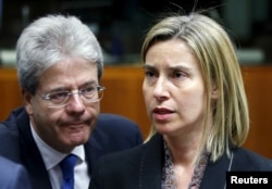 European Union foreign policy chief Federica Mogherini and Italian Foreign Minister Paolo Gentiloni (L) attend a meeting of European Union foreign and defence ministers at the EU Council in Brussels, Belgium, May 18, 2015.