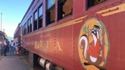 People get on the Skunk Train in Willits, Calif., Wednesday, Aug. 4, 2021. Robert Pinoli, president of Mendocino Railway, which owns the Skunk Train, said he is ready to help. Pinoli said he could find tank cars quickly and attach them to the train to deliver water to the town. (AP Photo/Haven Daley)