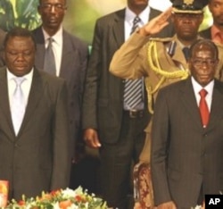 PM Morgan Tsvangirai (L) and President Robert Mugabe (R) are pictured at Zimbabwe International Investment Conference in Harare, 09 Jul 2009