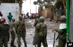 An opposition supporter throws a stone at riot police in Kibera Slums in Nairobi, Kenya, Thursday, Oct. 26, 2017.
