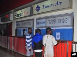 Relatives of passengers on the missing Trigana Air Service flight stand in front of its closed offices at Sentani airport in Jayapura, Papua province, Indonesia, Aug. 16, 2015.