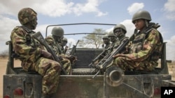 In this photo released by the African Union-UN Information Support Team, Kenyan soldiers serving with the African Union Mission in Somalia at their sector headquarters in Dhobley, September 30, 2012.