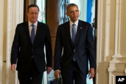 FILE - President Barack Obama and British Prime Minister David Cameron arrive for a joint news conference in the East Room of the White House in Washington, Friday, Jan. 16, 2015.