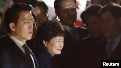 South Korea's ousted leader Park Geun-hye greets her supporters as she arrives at her private home in Seoul, South Korea, March 12, 2017.