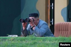 North Korean leader Kim Jong Un watches the test-fire of two short-range ballistic missiles, in this undated picture released by North Korea's Central News Agency, July 26, 2019.
