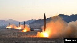 North Korean leader Kim Jong Un supervised a ballistic rocket launching drill of Hwasong artillery units of the Strategic Force of the KPA on the spot in this undated photo released by North Korea's Korean Central News Agency (KCNA) in Pyongyang March.