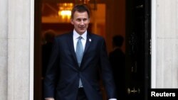 FILE - Britain's Foreign Secretary Jeremy Hunt leaves 10 Downing Street, London, Nov. 13, 2018.