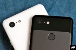 The cameras on the back of the Google Pixel 3 XL, left, and Google Pixel 3 smartphones are shown in this photo, in New York, Wednesday, Oct. 10, 2018. (AP Photo/Richard Drew)