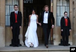 The newly married Duke and Duchess of Sussex, Meghan Markle and Prince Harry, leave Windsor Castle after their wedding in Windsor, to attend an evening reception at Frogmore House, hosted by the Prince of Wales, May 19, 2018.