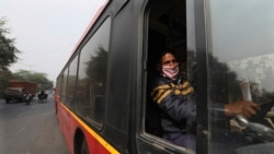 Delhi Transport Corporation bus driver Surinder Singh, 47, wearing a face mask as precaution against coronavirus and pollution drives in New Delhi, India, Wednesday, Nov. 25, 2020. (AP Photo/Manish Swarup)