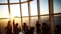People enjoy New Year's Eve during sunset amid the coronavirus disease (COVID-19) pandemic at the Seoul Sky Observatory in Seoul, Dec. 31, 2021.