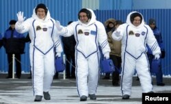 Members of the International Space Station expedition 54/55, Roscosmos cosmonaut Anton Shkaplerov, center, NASA astronaut Scott Tingle, right, and Norishige Kanai, left of the Japan Aerospace Exploration Agency during the send-off ceremony at the Baikonur
