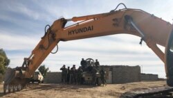 Kurdish Peshmerga forces oversee digging of defensive trenches in the village of Lheiban , Iraq, Dec. 7, 2021.