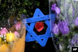 A Star of David fashioned from ice pop sticks hangs from bushes outside the Tree of Life Synagogue in Pittsburgh, Nov. 20, 2018.
