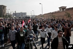Coptic Christians protest on a street after a funeral service for victims of a Sunday cathedral bombing, at the Virgin Mary Church, in Cairo, Egypt, Dec. 12, 2016.