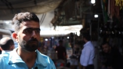 Essam Hassan, 28, sells vegetables for a living and says he cannot afford to take time off work to be vaccinated, even if it is available, Oct. 18, 2021, in Qameshli, Syria. (Heather Murdock/VOA)