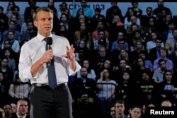French President Emmanuel Macron answers a question from student in the audience during a town hall meeting at George Washington University in Washington, April 25, 2018.
