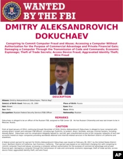 FILE - This wanted poster provided by the FBI shows Dmitry Aleksandrovich Dokuchaev, 33, a Russian national. A U.S. indictment of two Russian intelligence agents and two hackers alleged to have stolen more than half a billion U.S. email accounts in 2014 has cast a spotlight on the intertwining of the Russian security services and the murky digital underworld.