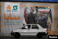 FILE - A man drives a car inside the Saipa Syria Factory in the industrial city of Hassia in Homs, Syria, Sept. 9, 2018.